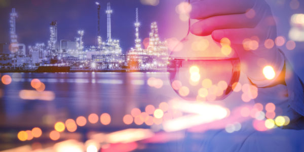 Double exposure of laboratory test tube and Oil refinery plant