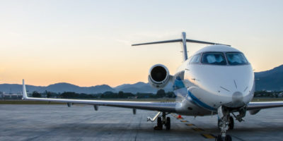 Small Airplane or Aeroplane Parked at Airport.Small Airplane Famous to use Private Airplane.Sunset Light and Mountain View.